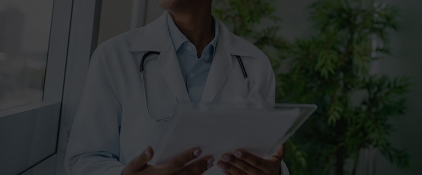 Health professional reviewing patient information indoors.