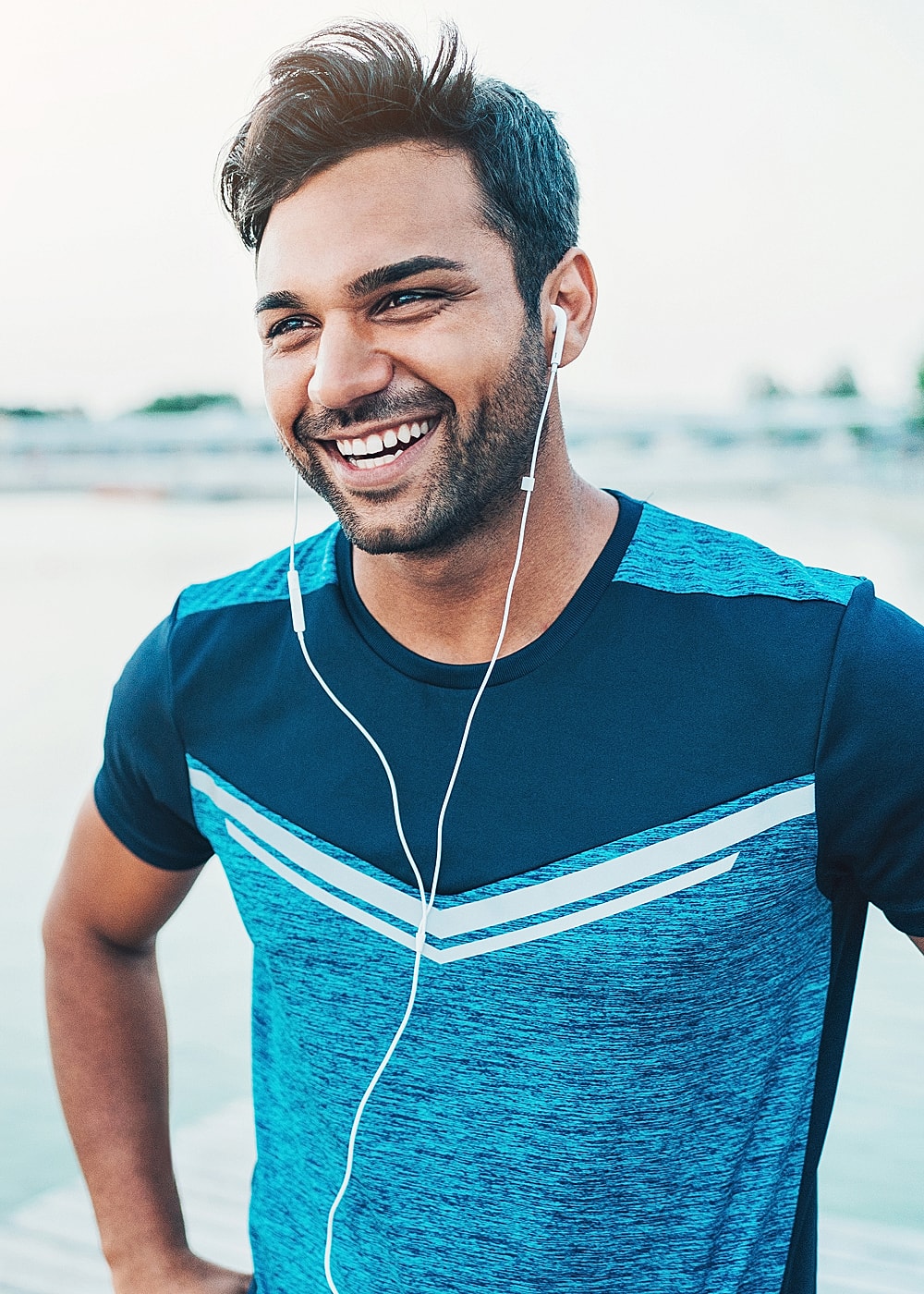 Woman with long hair in athletic wear outdoors.