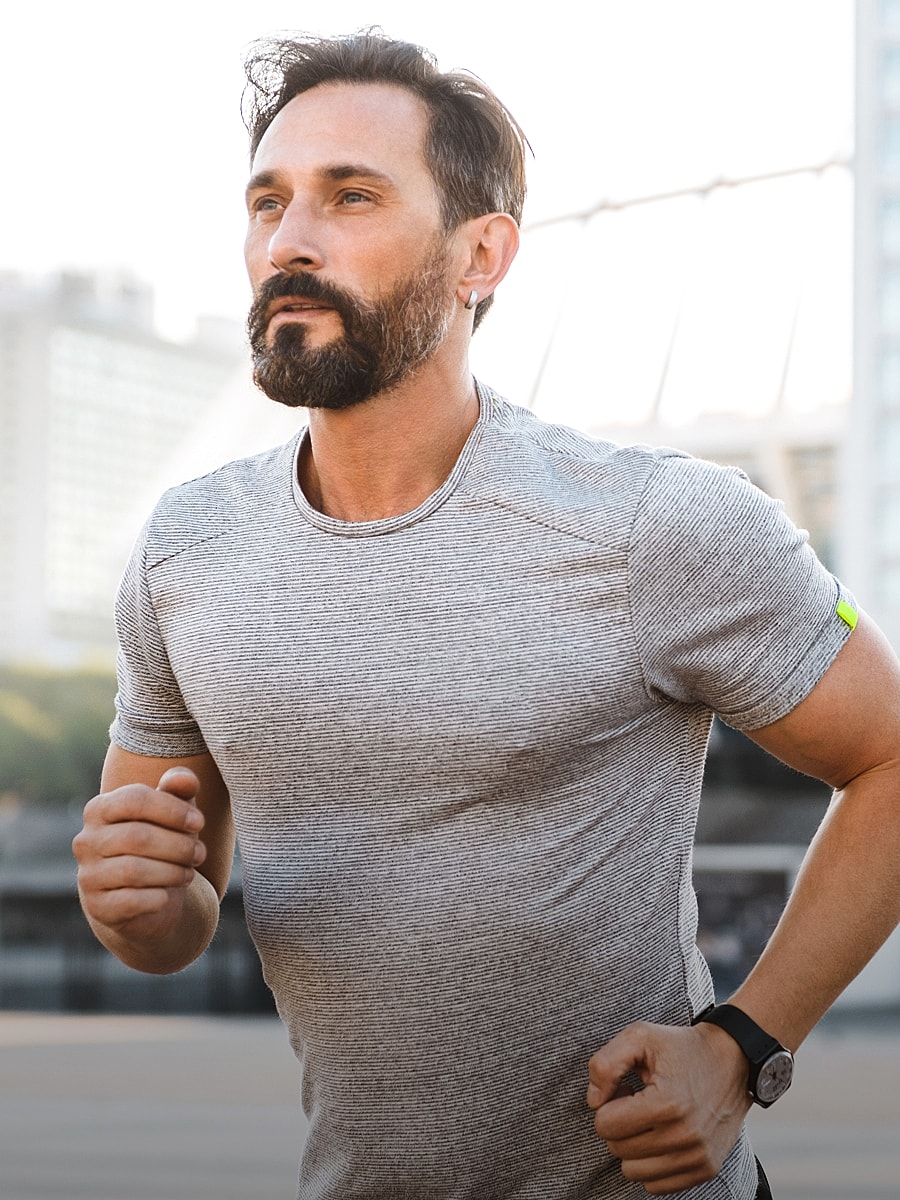 Man jogging outdoors in athletic wear.