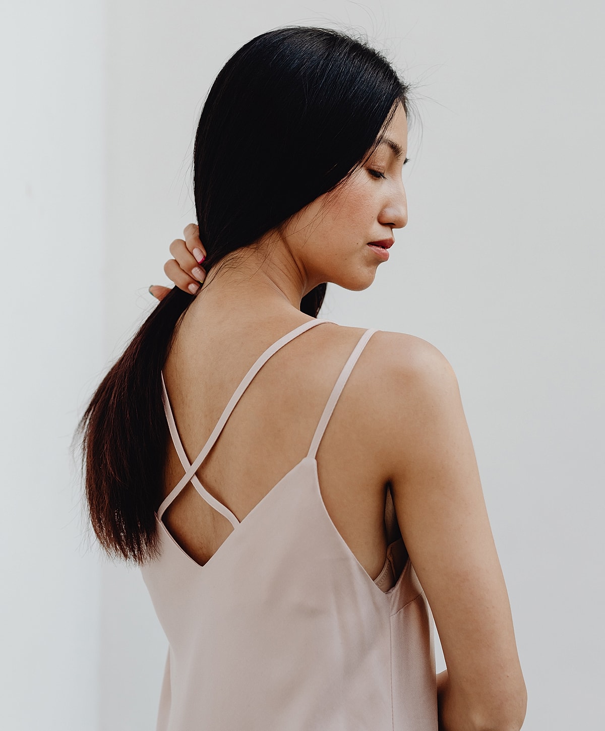 Woman with long hair in elegant top.