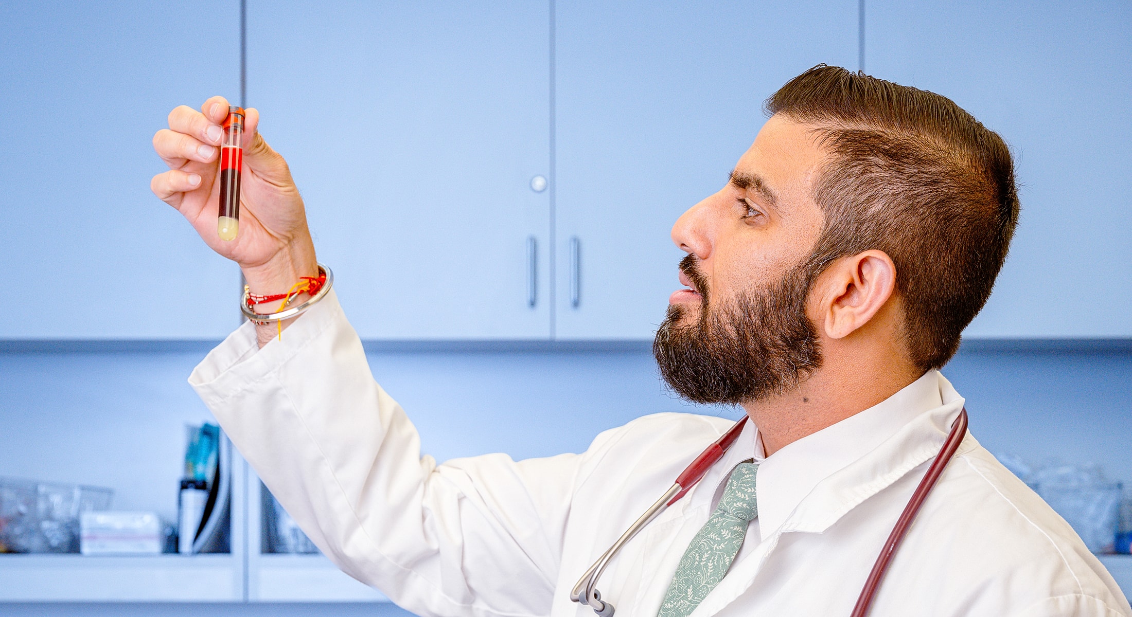 Doctor examining a blood sample in laboratory.