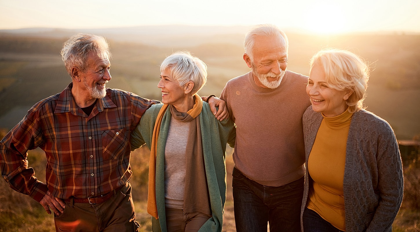 Happy seniors enjoying time together at sunset.